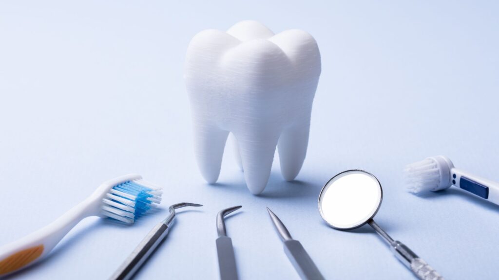 Dental Tools Around A Large Tooth Model